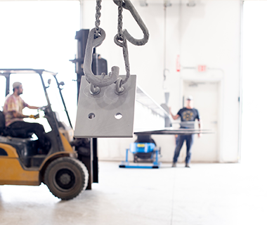 employee driving fork lift