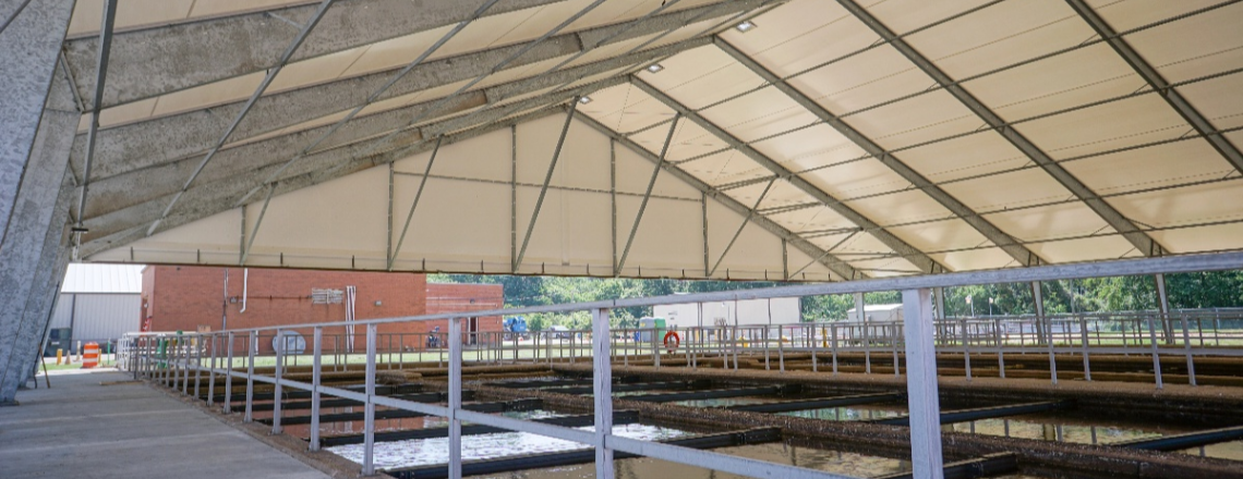 Wastewater treatment facility with a tension fabric building