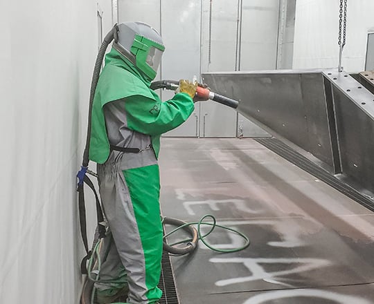 painter in epoxy paint booth