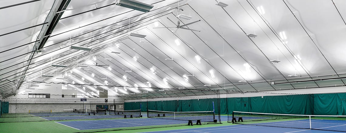 suspended lighting in tension fabric tennis building