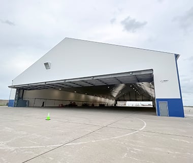 tension fabric aircraft hangar with door open