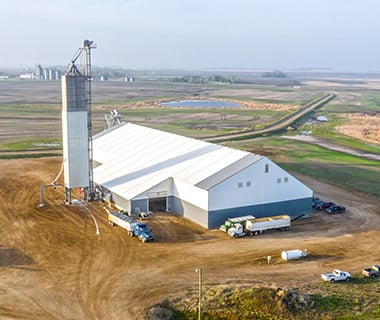 gray and white tension fabric building for bulk storage